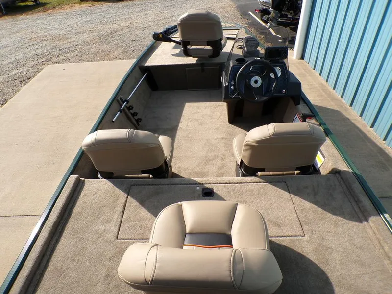 Slide: The Image of 2025 Tracker Bass Tracker® Classic Limited boat interior with beige seating and steering console. - 12