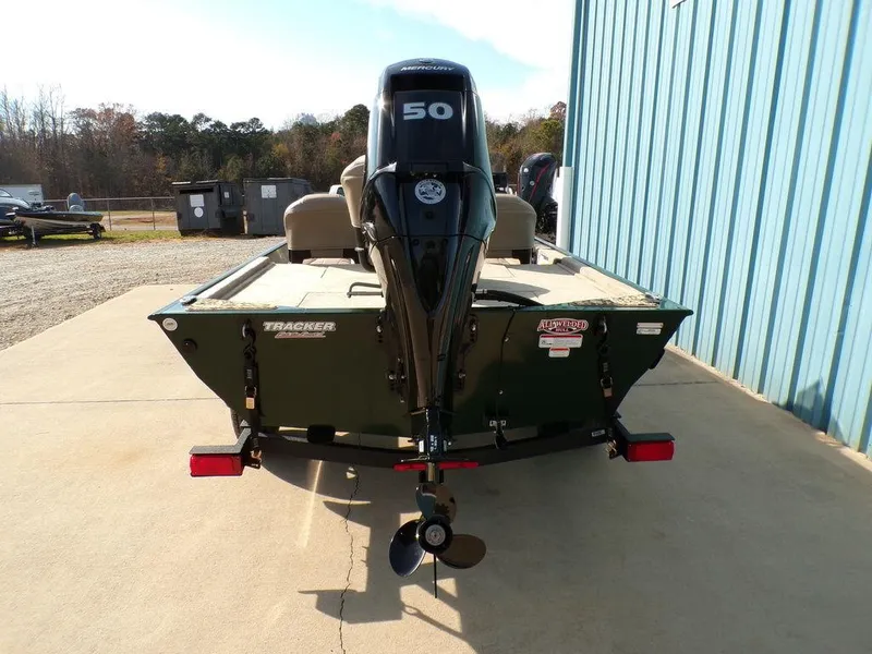 Slide: The Image of 2025 Tracker Bass Tracker® Classic Limited boat with 50 HP motor, parked outdoors. - 7