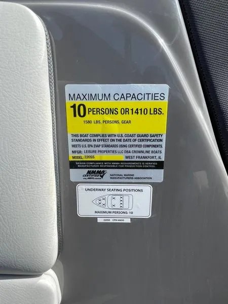 Slide: The Image of 2023 Crownline 220 SS LPX capacity label: 10 persons or 1410 lbs maximum. - 10