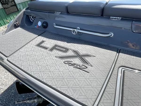 Slide: The Image of 2023 Crownline 220 SS LPX boat deck with textured surface and LPX branding. - 12