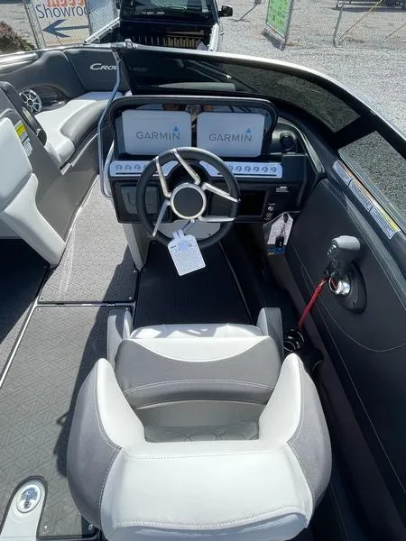 Slide: The Image of 2023 Crownline 220 SS LPX boat interior with Garmin displays and modern steering wheel. - 6