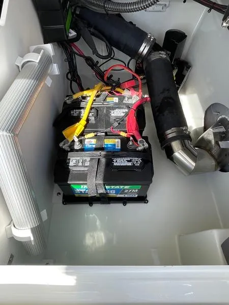 Slide: The Image of 2023 Crownline 220 SS LPX boat battery compartment with wiring and components. - 9
