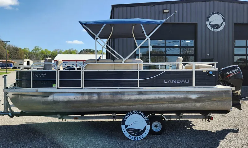 Slide: The Image of 2015 Landau A'Lure 212 Fishing pontoon boat with blue canopy on trailer. - 2