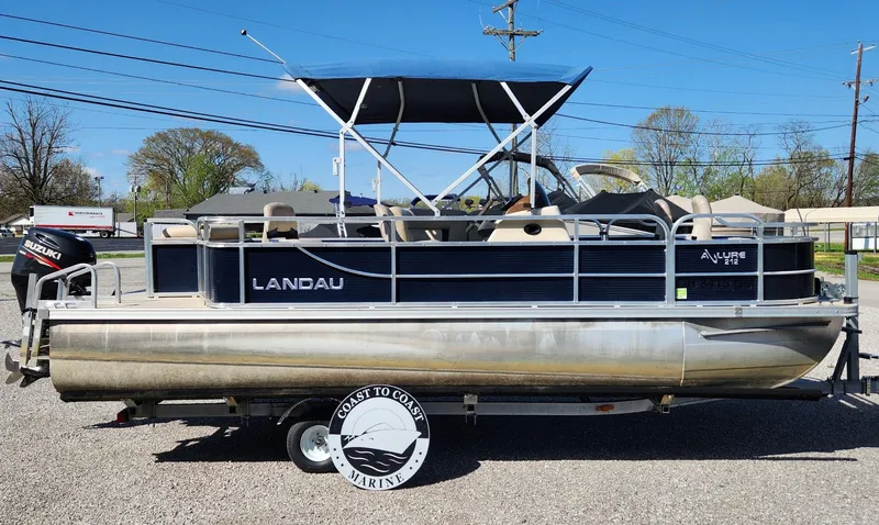 Slide: The Image of 2015 Landau A'Lure 212 Fishing pontoon boat with canopy, parked on gravel. - 3