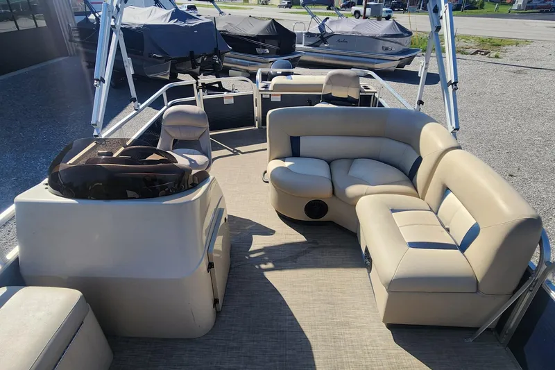 Slide: The Image of 2015 Landau A'Lure 212 Fishing boat interior with beige seating and steering console. - 6