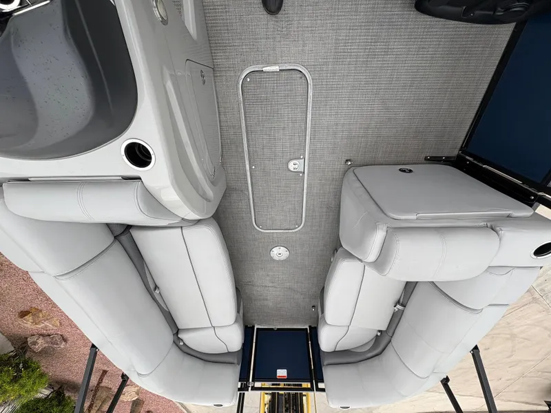 Slide: The Image of 2019 Regency 210 DL3 boat interior with gray seating and carpeted floor. - 10