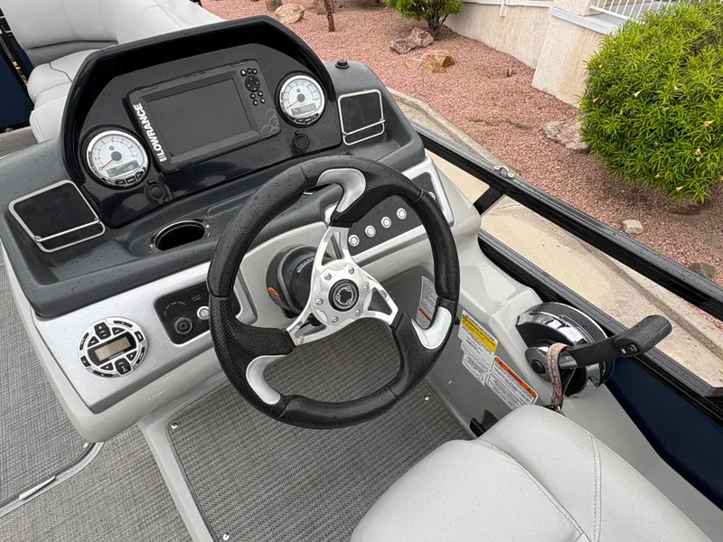 Slide: The Image of 2019 Regency 210 DL3 boat dashboard with steering wheel and control panel. - 14