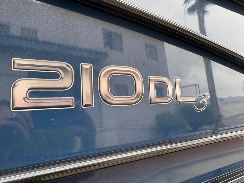 Slide: The Image of 2019 Regency 210 DL3 logo on a blue surface, reflecting surroundings. - 4