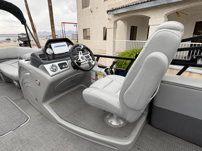 Slide: The Image of 2019 Regency 210 DL3 boat interior with steering console and captain's chair. - 7