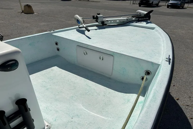 Slide: The Image of 1999 BAYCRAFT 18 SKIFF boat interior with MotorGuide trolling motor, parked on asphalt. - 5