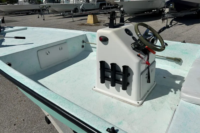 Slide: The Image of 1999 BAYCRAFT 18 SKIFF boat interior with steering console and rod holders. - 8