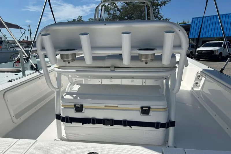Slide: The Image of 2020 Frontier 2104 CC boat interior with rod holders and cooler. - 10