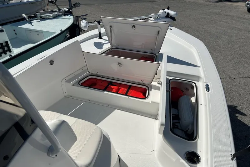 Slide: The Image of Open storage compartments on a 2020 Frontier 2104 CC boat deck. - 12