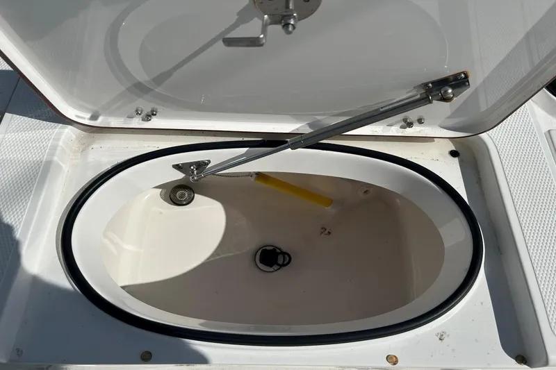 Slide: The Image of Open storage compartment on a 2020 Frontier 2104 CC boat, showing interior details. - 16