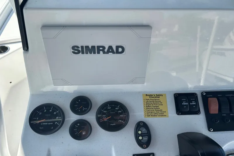 Slide: The Image of Dashboard of a 2020 Frontier 2104 CC boat with Simrad display and gauges. - 18