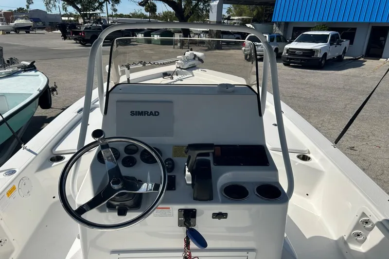 Slide: The Image of 2020 Frontier 2104 CC boat console with steering wheel and Simrad display. - 6