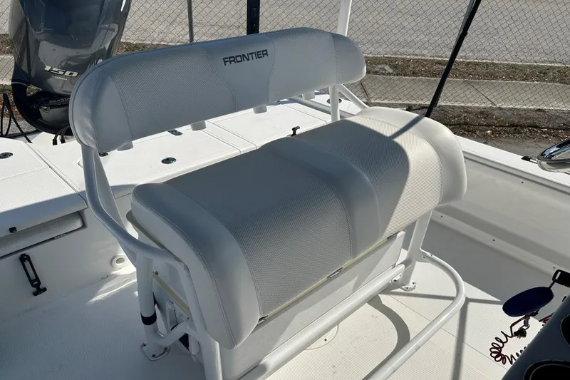 Slide: The Image of White seating on a 2020 Frontier 2104 CC boat, with a visible outboard motor. - 7