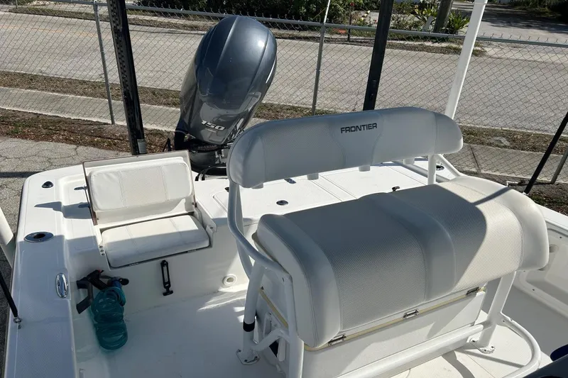 Slide: The Image of 2020 Frontier 2104 CC boat interior with seating and outboard motor. - 8