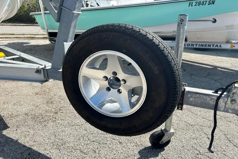 Slide: The Image of Trailer wheel for 2021 Sea Pro 219 Deep-V boat on pavement. - 16