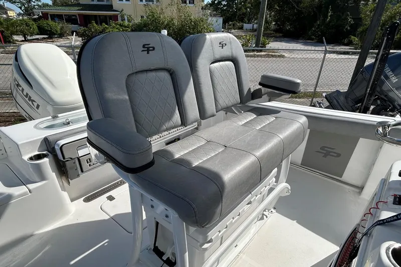 Slide: The Image of 2021 Sea Pro 219 Deep-V boat with dual gray cushioned seats and armrests. - 3