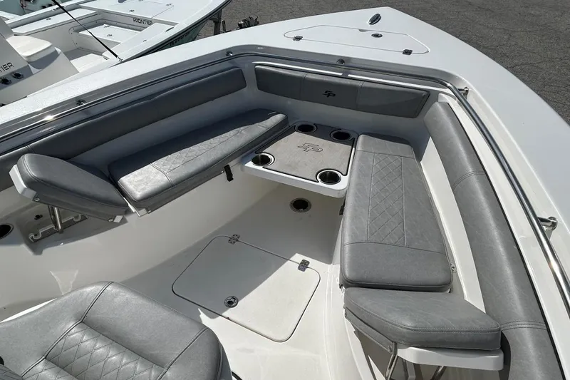 Slide: The Image of 2021 Sea Pro 219 Deep-V boat interior with gray cushioned seating and cup holders. - 8