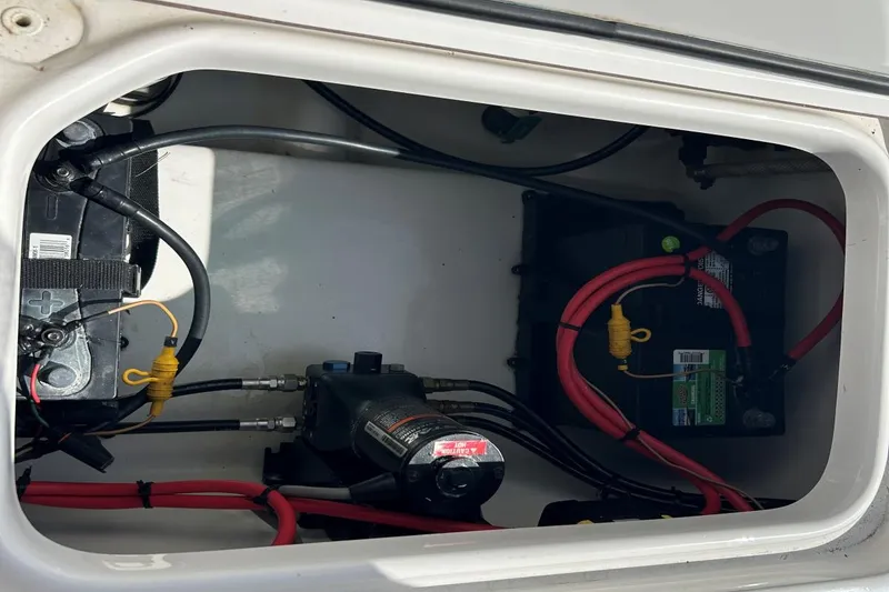 Slide: The Image of 2021 Sea Pro 219 Deep-V boat battery compartment with wiring and components. - 18