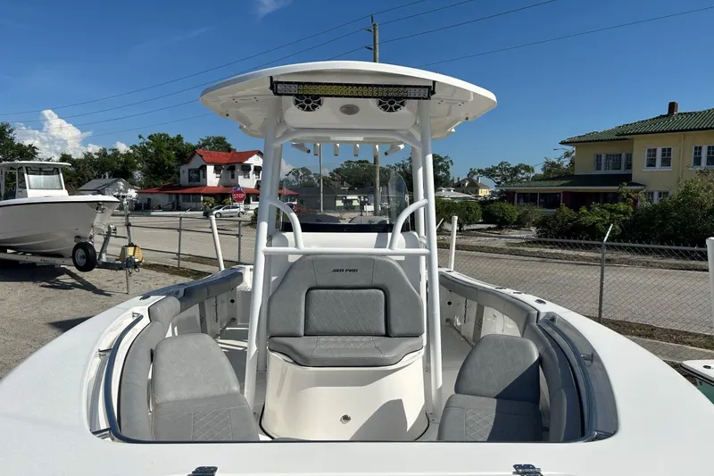 Slide: The Image of 2021 Sea Pro 219 Deep-V boat with T-top and seating, parked outdoors. - 22