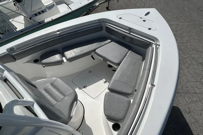 Slide: The Image of 2021 Sea Pro 219 Deep-V boat interior with gray cushioned seating and storage compartments. - 4