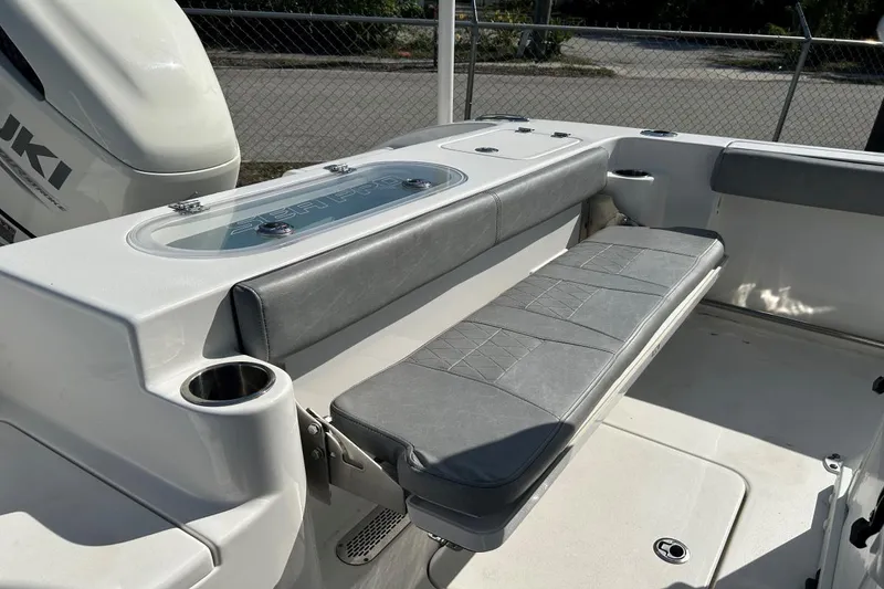 Slide: The Image of 2021 Sea Pro 219 Deep-V boat interior with cushioned seating and cup holders. - 7