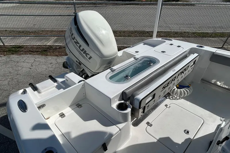 Slide: The Image of 2021 Sea Pro 219 Deep-V boat with Suzuki outboard motor, docked on pavement. - 8