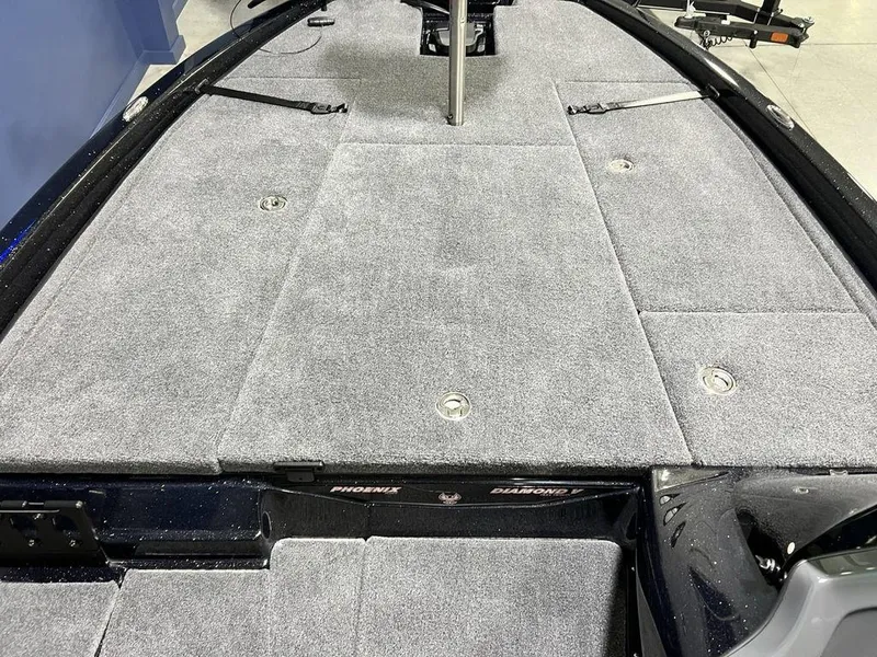 Slide: The Image of 2025 Phoenix 920 Elite boat deck with gray carpet and storage compartments. - 11