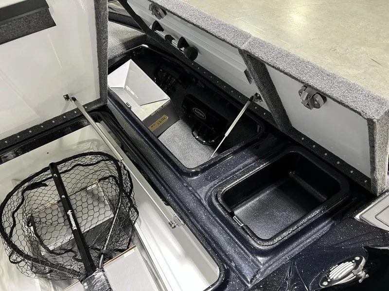 Slide: The Image of Open storage compartments in a 2025 Phoenix 920 Elite boat, featuring fishing gear and equipment. - 15