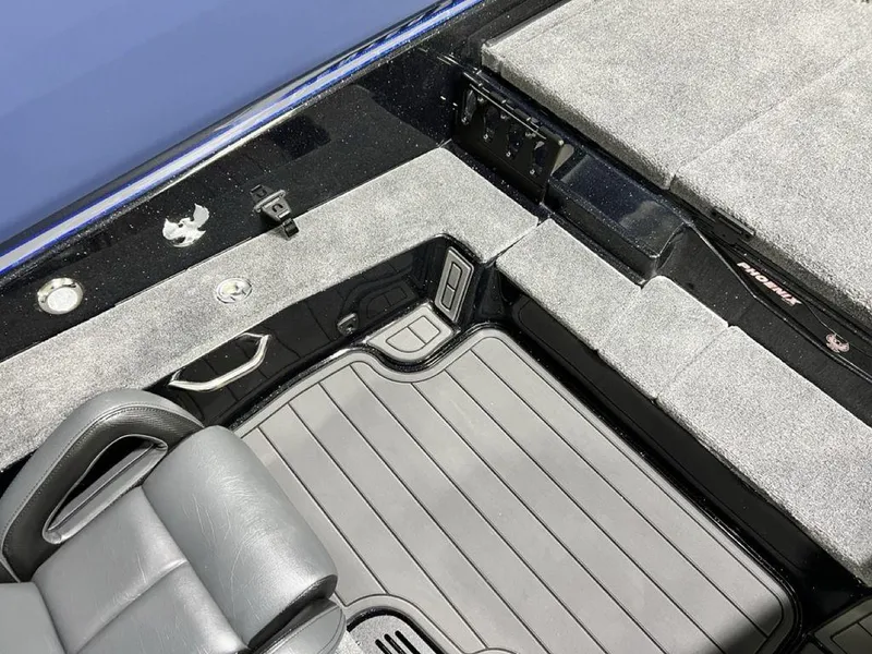 Slide: The Image of Interior of 2025 Phoenix 920 Elite boat with gray seating and carpeted flooring. - 17