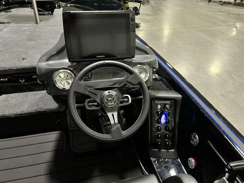 Slide: The Image of Cockpit of 2025 Phoenix 920 Elite boat with steering wheel and digital display. - 21