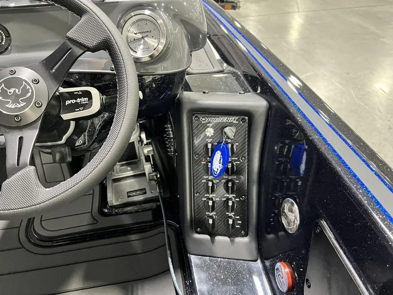 Slide: The Image of Interior of 2025 Phoenix 920 Elite boat, featuring steering wheel and control panel. - 23
