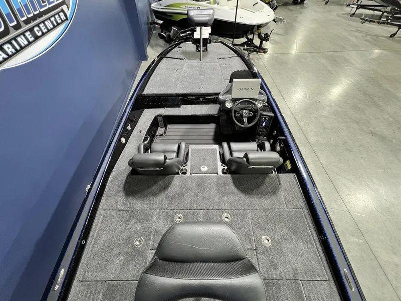 Slide: The Image of 2025 Phoenix 920 Elite boat interior with steering console and seating, displayed in a showroom. - 30