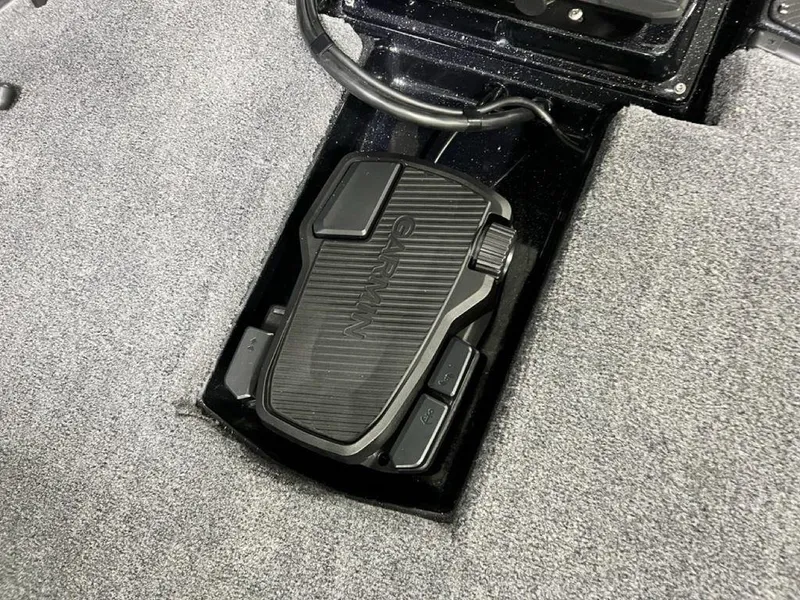 Slide: The Image of Foot pedal in a 2025 Phoenix 920 Elite boat, integrated into carpeted flooring. - 7