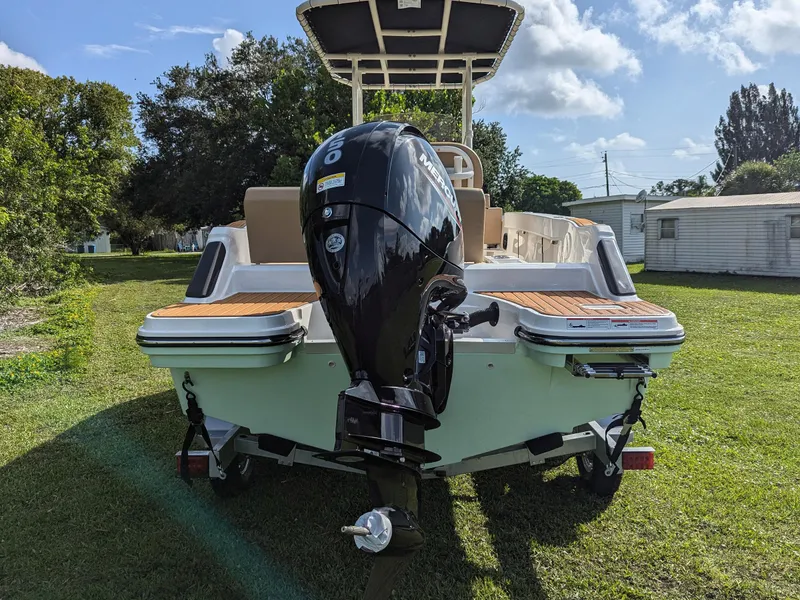 Slide: The Image of 2025 Bayliner Trophy T20CC boat with outboard motor on grassy area. - 6