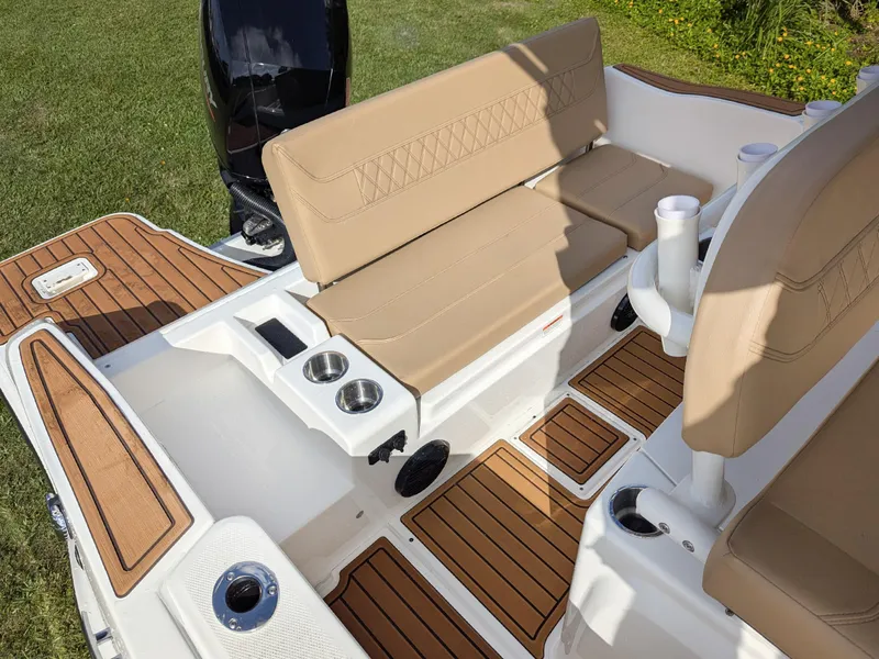Slide: The Image of 2025 Bayliner Trophy T20CC boat interior with tan seating and wood accents. - 7