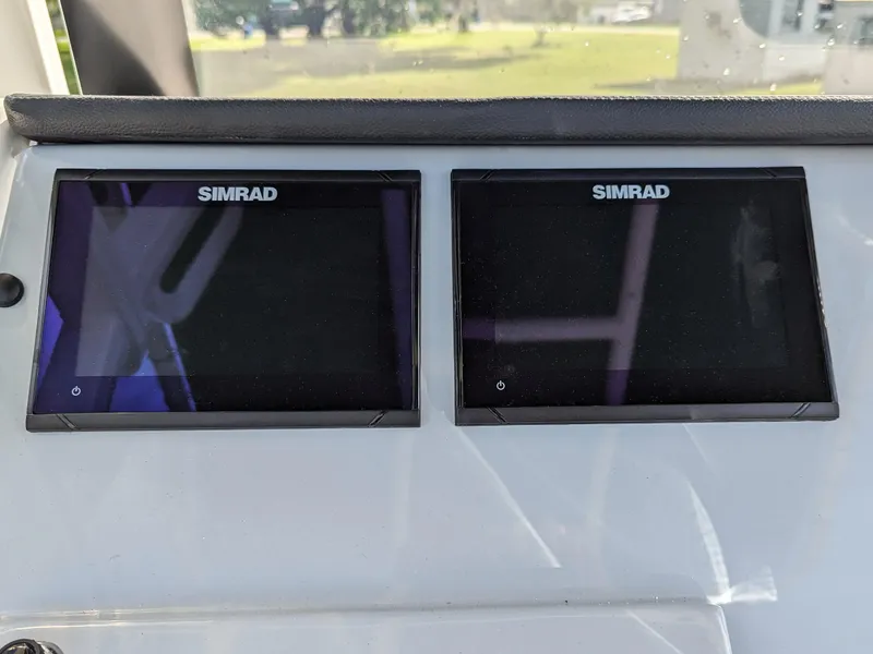 Slide: The Image of Dual Simrad displays on 2025 Bayliner Trophy T20CC boat dashboard. - 9