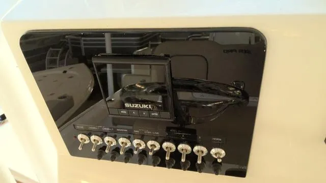Slide: The Image of Control panel of 2025 Sea Pro 210 Bay boat with Suzuki display and switches. - 15