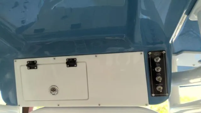 Slide: The Image of 2025 Sea Pro 210 Bay boat console with storage compartment and control panel. - 17