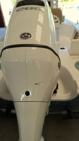 Slide: The Image of 2025 Sea Pro 210 Bay boat with powerful outboard motor in a showroom. - 20