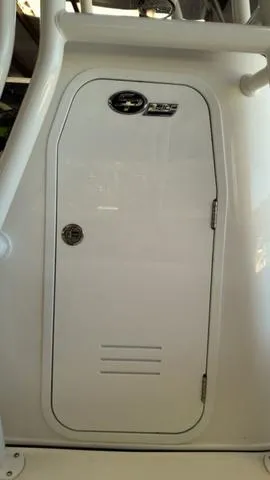Slide: The Image of 2025 Sea Pro 210 Bay boat console door, white with chrome handle. - 5