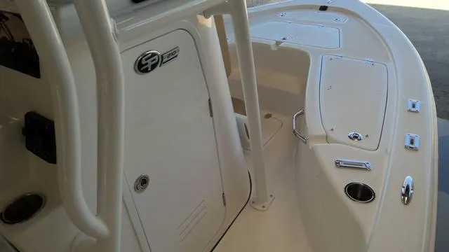 Slide: The Image of 2025 Sea Pro 210 Bay boat interior with storage compartments and cup holders. - 7