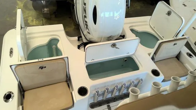 Slide: The Image of 2025 Sea Pro 210 Bay boat interior with storage compartments and Suzuki engine. - 8
