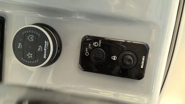 Slide: The Image of 2025 Sea Pro 222 Center Console boat controls with Suzuki ignition and SeaStar steering knob. - 14