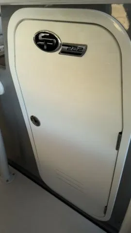 Slide: The Image of 2025 Sea Pro 222 Center Console boat compartment door with logo. - 20
