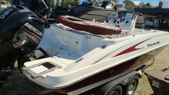 Slide: The Image of 2019 Tahoe 2150 CC boat with Mercury outboard motor, parked on a trailer. - 1