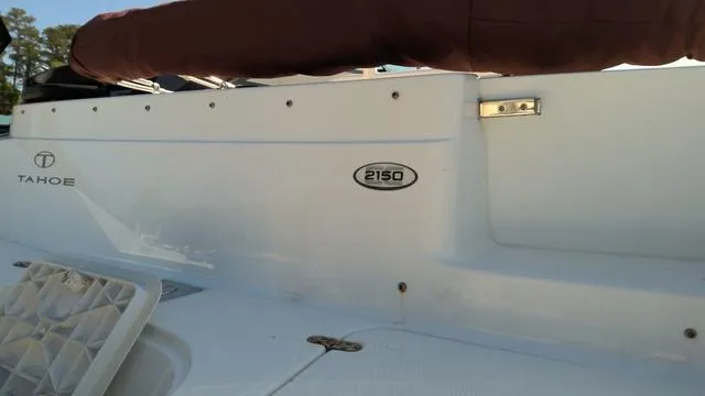 Slide: The Image of 2019 Tahoe 2150 CC boat side view with logo and model details. - 2